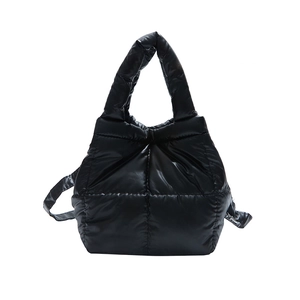 Minimalist black quilted puffer tote bag with handles and strap on white background