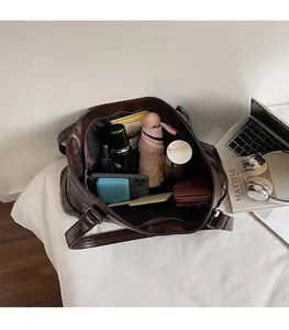 Spacious interior of a vintage dark brown tote bag showing large storage capacity