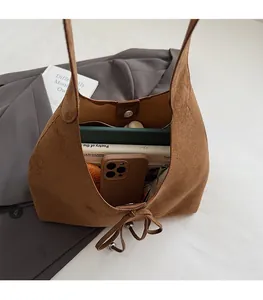 Top view of a large brown suede tote bag showing its spacious interior and drawstring detail