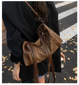 Detail view of the brown canvas Boston bag showing texture and adjustable leather straps