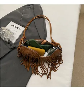 Internal view of brown suede tassel bag showing capacity for phone, wallet and cosmetics