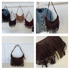 Detail shot of bohemian fringe hobo bag with wooden beads and suede texture