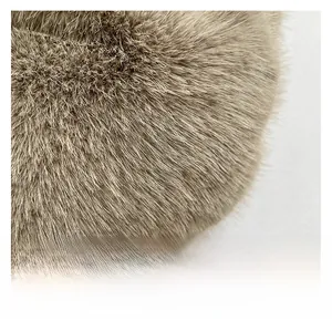 Close-up of dense brown faux fur fabric showing soft plush texture and silky sheen
