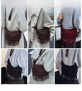 Detail view of suede fringe crossbody bags in brown, burgundy, and black styles