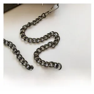 Detail of a dark grey metallic chain strap with rugged industrial style metal hook