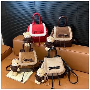 Detail of four colorful suede mini backpacks with plush trim and cute bear charms