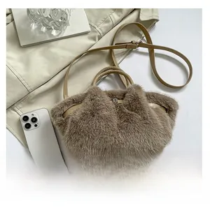 Detail of plush bucket bag in brown faux fur with leather strap and metal clasp