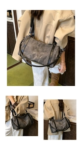 Detail view of the vintage grey matte boston bag with contrast black leather straps