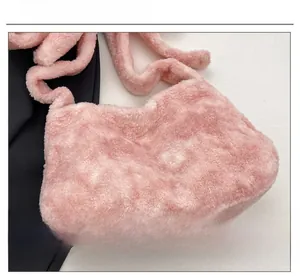 Detailed macro shot of the soft pink plush faux fur texture and curly fleece material