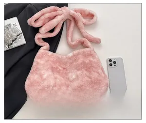 Detail shot of the pink plush bucket bag featuring a soft oversized decorative bow strap
