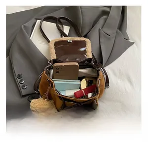 Top view of brown suede bucket backpack showing interior space with phone and notebook
