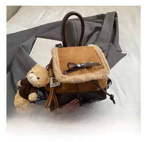 Mini backpack featuring caramel suede with faux fur trim and cute bear charm detail