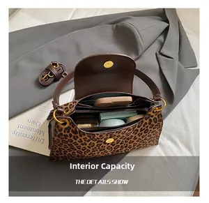 Internal capacity of leopard print shoulder bag showing space for phone and makeup