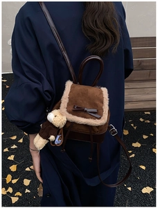 Brown frosted backpack with plush trim, bow detail and a cute bear charm in autumn setting