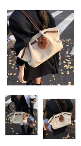 Detail of beige canvas tote bag with brown leather trim and plush donut pendant decor