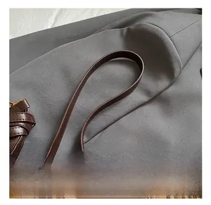 Detail of leopard print faux fur handbag featuring premium brown leather handle and metal ring