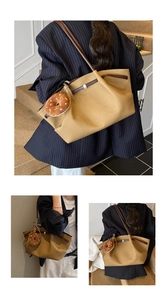 Detail of khaki tote bag with brown leather trim and cute donut plush charm accessory