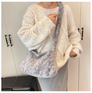 Detail of soft grey plush crossbody bag showing the fluffy texture and wide strap
