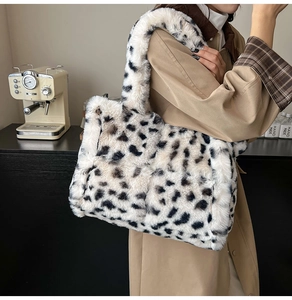 Detail of soft leopard print faux fur tote bag showing plush texture and wide shoulder strap