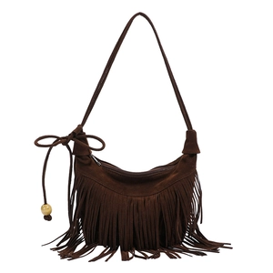 Detailed close-up of brown suede hobo bag with bohemian fringe and drawstring tassel