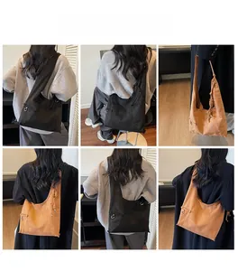 Detailansicht der großen Wildleder-Einkaufstasche mit Metallringen in Schwarz und Camel