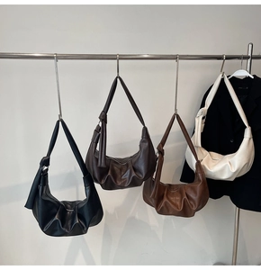 Detailed view of large ruched hobo bags in black, brown, caramel, and cream colors