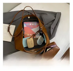 Interior storage capacity of a large brown suede tote bag showing everyday essentials
