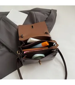 Detail view of the brown vintage crossbody bag showing multi-layer interior and storage capacity