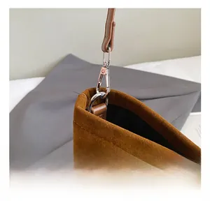 Detail shot of the silver metal hook and brown suede texture on this large tote bag