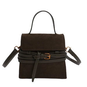 Dark brown suede handbag with decorative strap and gold buckle in a minimalist retro style