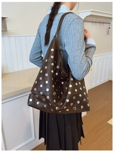Detail of soft brown tote bag with metallic silver studs and bohemian rivet design