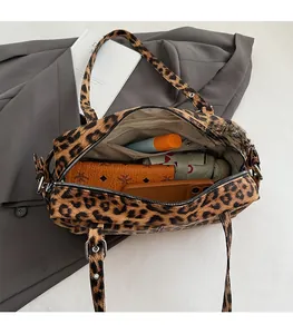 Vue intérieure montrant la grande capacité du sac léopard avec des objets du quotidien