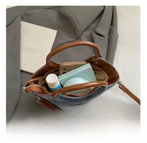 Detailed interior view of denim bucket bag showing space for phone and essentials