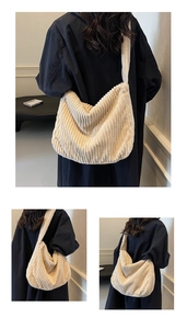 Detail of soft cream corduroy tote bag showing thick ribbed fabric and wide shoulder strap