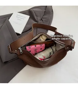 Detail view of the spacious interior capacity of a brown pleated soft leather handbag