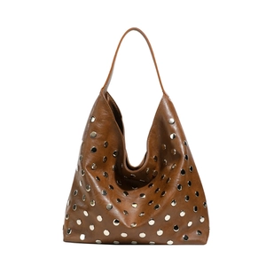 Sac hobo en cuir marron avec rivets métalliques argentés et fine bandoulière sur fond blanc