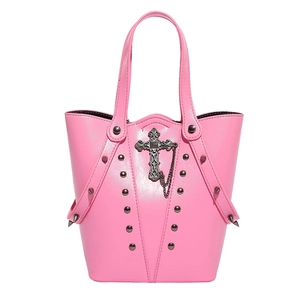 Pink gothic punk bucket bag with silver cross charm and metallic studs on white background