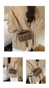 Détail du sac boîte vintage en daim marron vu de dos et de côté avec un mannequin