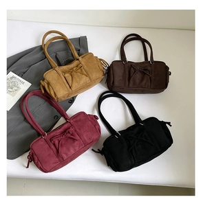 Detalle de bolsos de hombro vintage con lazo en ante y varios colores de otoño