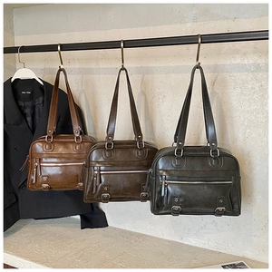 Retro Boston tote bags in three colors hanging on a wall for a vintage workplace style