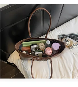 Top view of brown leather tote bag showing large capacity for tablet, umbrella, and essentials