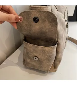 Detail of vintage tote side pocket with magnetic closure and brushed faux leather texture