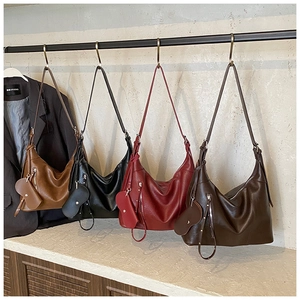 Detail view of large capacity faux leather moon bags in four colors with heart charms