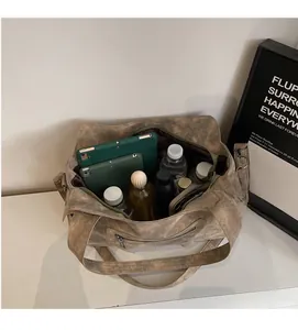 Top view of spacious interior of retro brown tote bag filled with daily essentials
