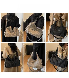 Model wearing vintage large matte tote bag in dark grey and black with shoulder strap