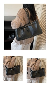 Close-up of black leather tote bag featuring retro buckle detail and vintage aesthetic