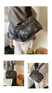 Detail of black vintage PU leather pillow bag with silver buckles and polished finish