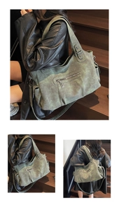 Detail view of large greyish-green vintage tote bag with functional pockets and metal zippers