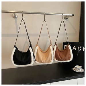 Suede and faux fur hobo bags in black, beige, and brown on metal display stands