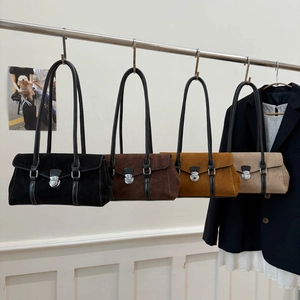 Detail view of four minimalist vintage shoulder bags in black, brown, tan, and beige